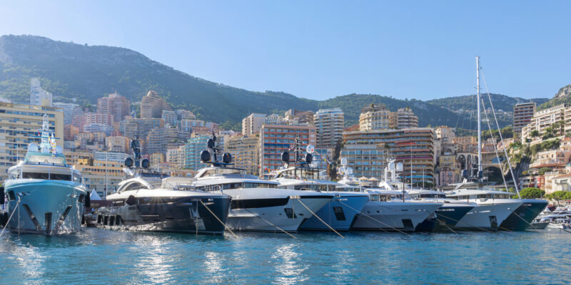 Yachts,Moored,In,Monaco,Harbour,With,Monaco,Landscape,On,A